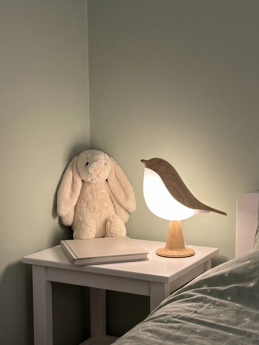 Songlow bird lamp on a child’s bedside table