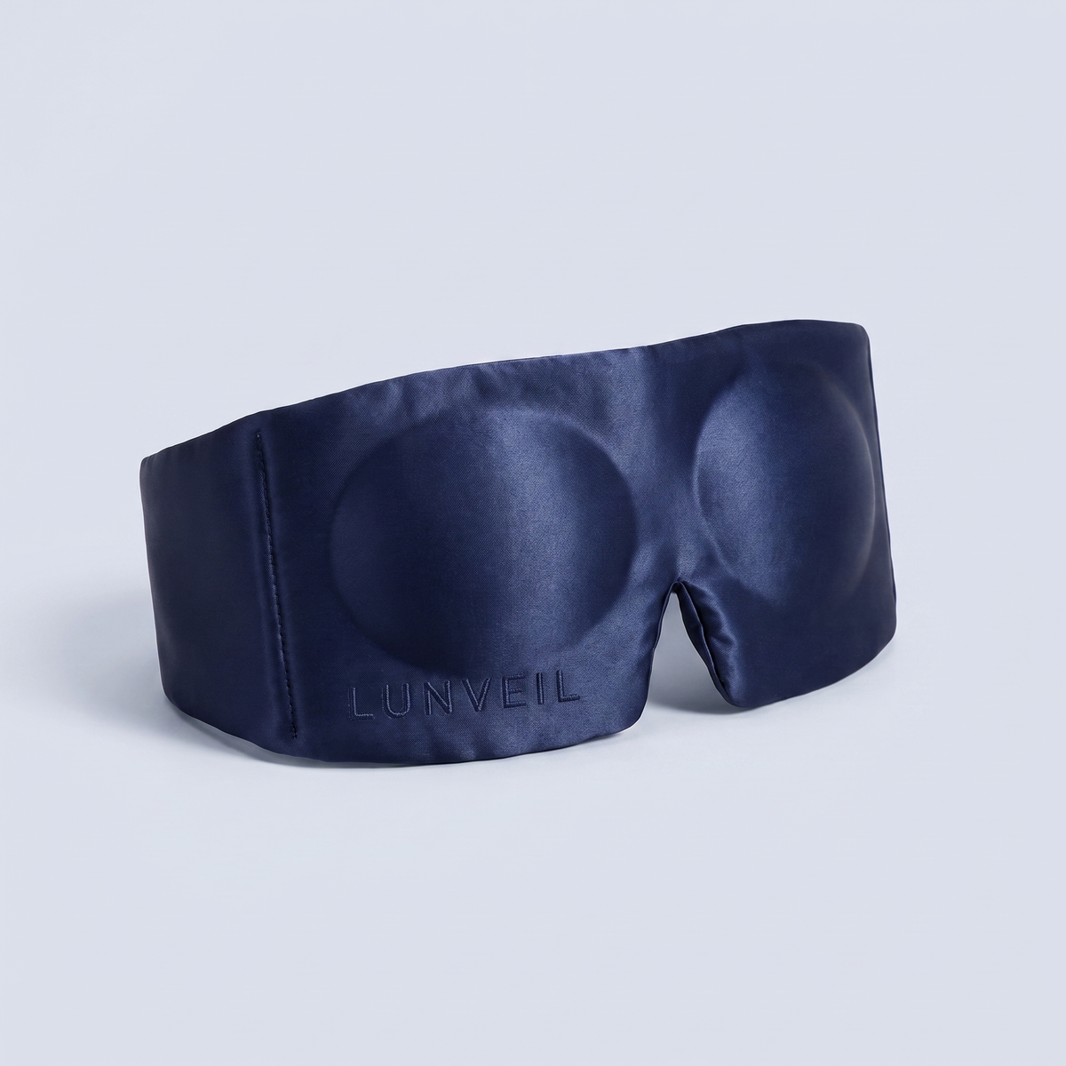 LUNVEIL Contour 3D silk sleep mask in Midnight Sapphire, front-on on a pale grey studio background