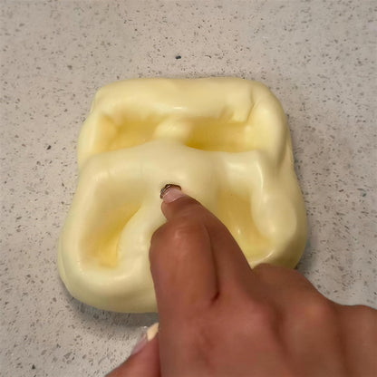 Deep finger dents staying in the yellow CHEDDI cheese squishy