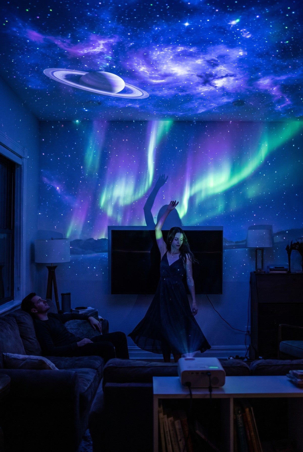 A dark living room with a galaxy projected across the ceiling